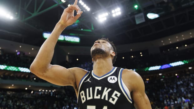 Milwaukee Bucks forward Giannis Antetokounmpo (34) points to the sky 